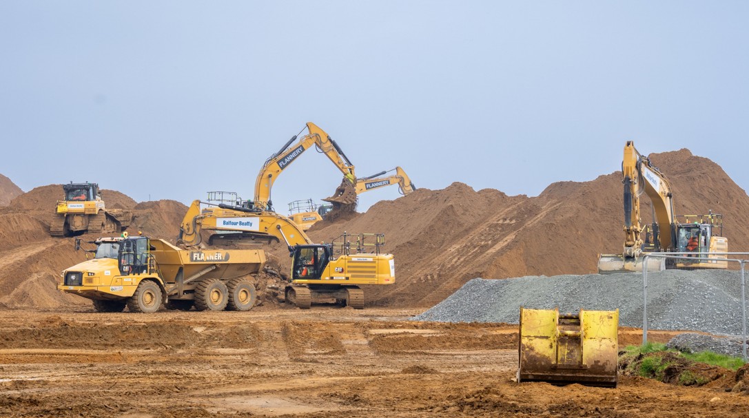Yellow excavators moving earth in a big construction site - Sizewell C forms civils alliance with three construction giants