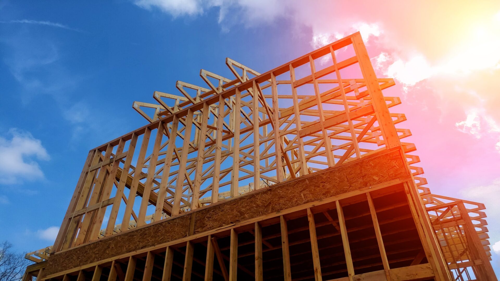 Timber frame house, new build roof with wooden truss, post and beam framework home construction framing - timber frame manufacturers say that regulatory ambiguity is hindering MMC.