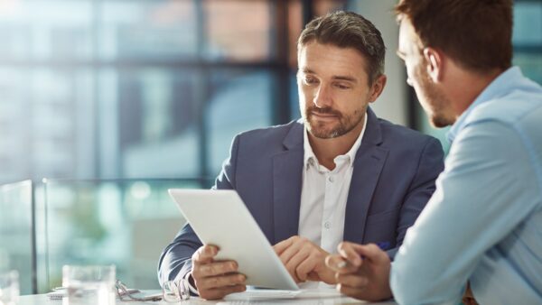 Image of people discussing finances for construction management project management piece