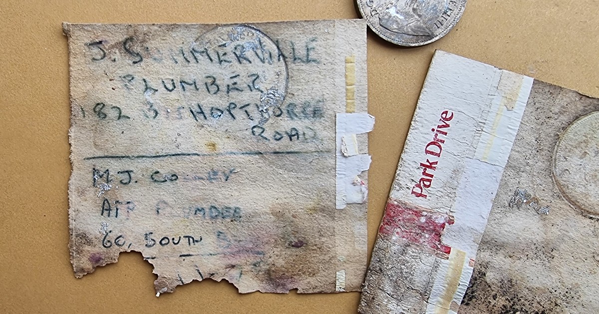 An old Park Drive cigarette box with handwriting on it and an old 10p coin