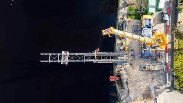 A temporary bridge structure being lifted by a crane - Mabey Hire designed a temporary bridge for Balfour Beatty during refurb works of Otley Bridge.