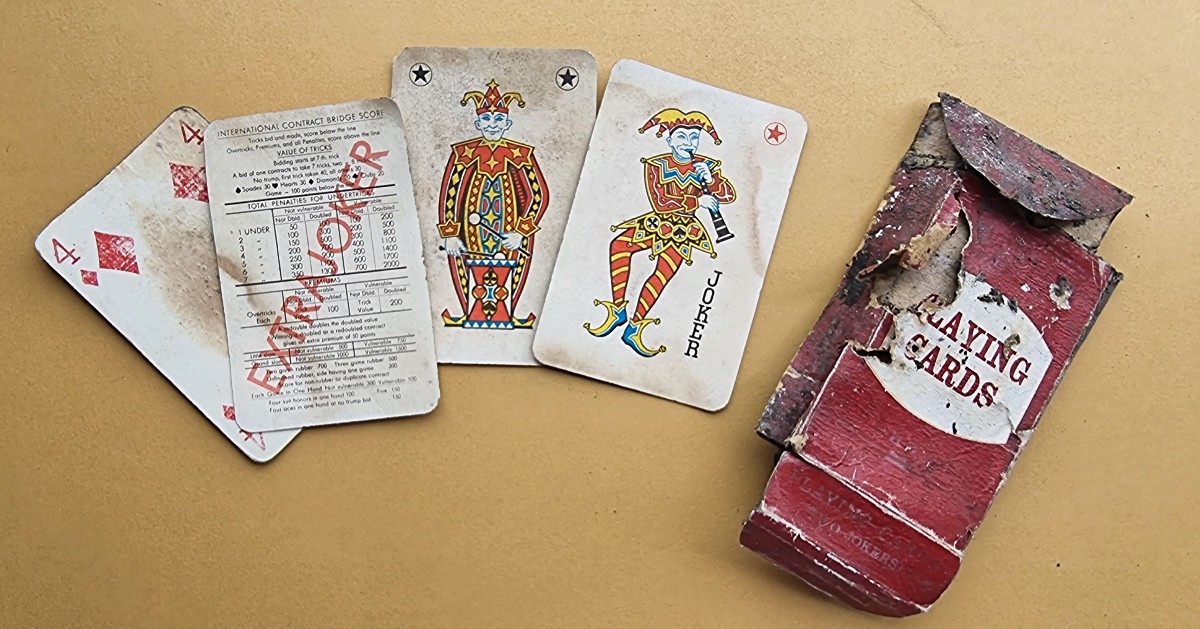 Four old playing cards and their box