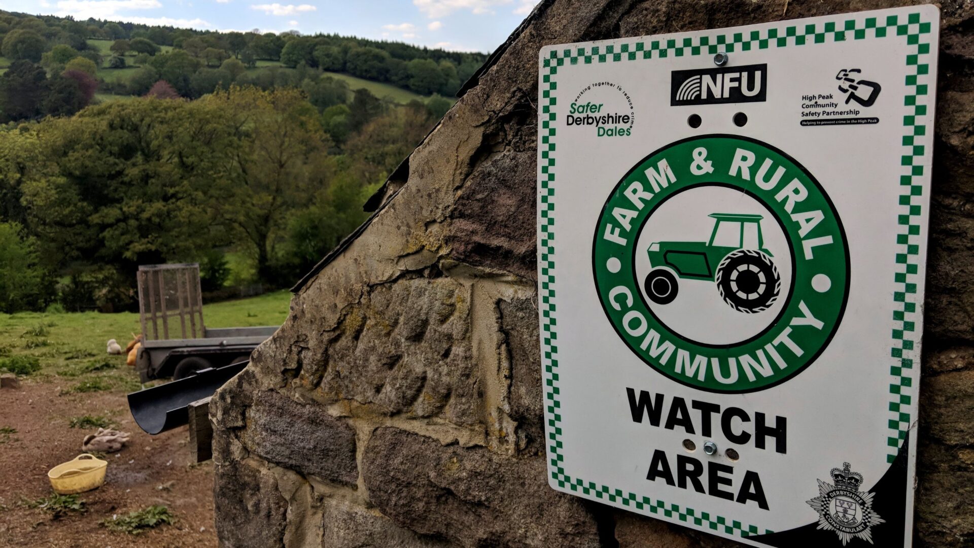 A sign on a stone wall that says 