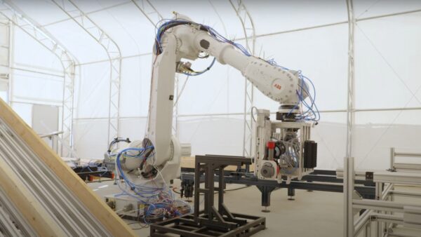 An ABB robot assembling parts for a home in a California micro-factory for robotics Los Angeles rebuild story