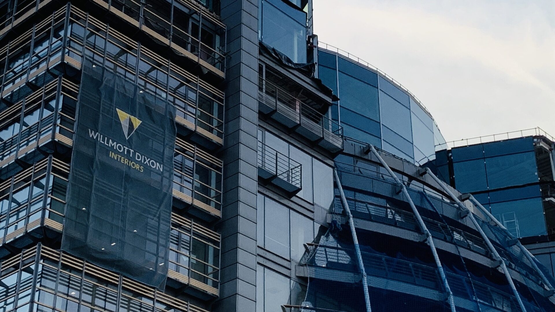 A big glass office building with a sign that says Willmott Dixon - Willmott Dixon has succeeded in an application to change the name of a company with a very similar name.
