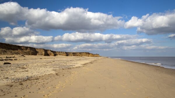 A beach and the sea in a clear day - Benacre Beach, Suffolk, England. Balfour Beatty has been awarded a flood defence contract.