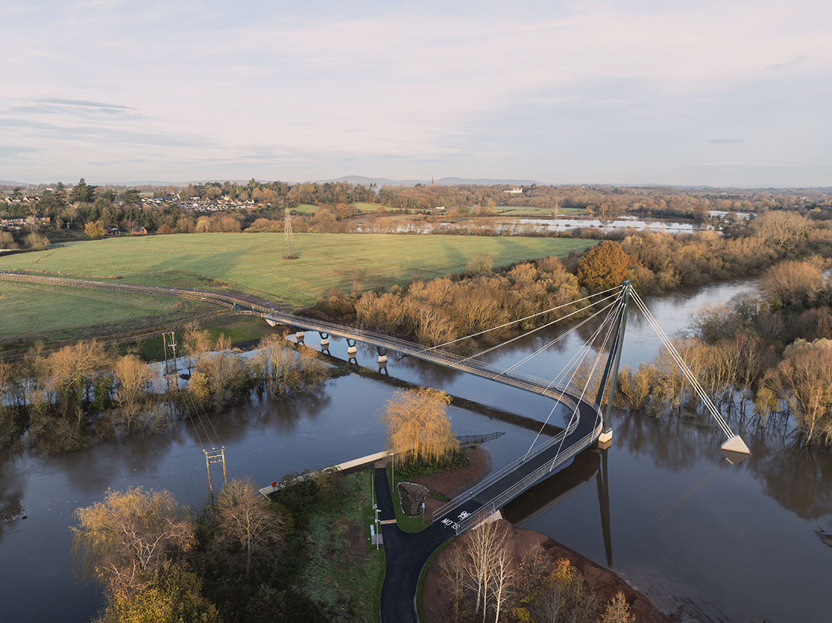 The cable-stayed pedestrian and cycle bridge has a ‘hockey stick’ deck alignment to avoid flood-prone areas. Image: Moxon Architects