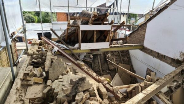 A construction site where a roof has collapsed on a home, there's debris everywhere - a builder has avoided jail after a roof collapsed, destroyed a home and injured three workers