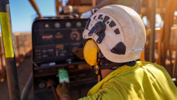 Construction worker wearing safety noise disruptive earmuffs protection at a construction site