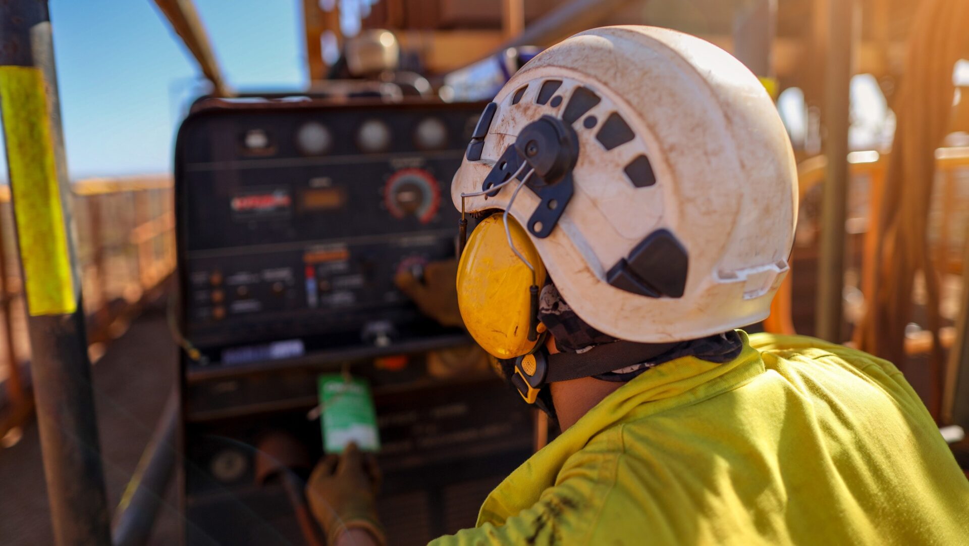 hearing protection - Construction worker wearing safety noise disruptive earmuffs protection at a construction site