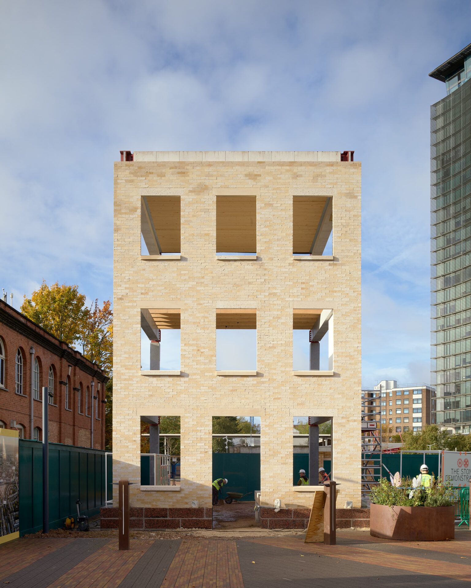 A three-storey structure made of light-coloured bricks