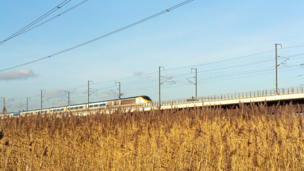 A high-speed train going through a wheat field